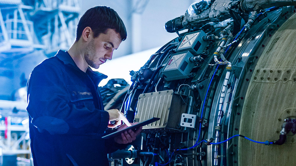 Worker using a tablet to analyze a part